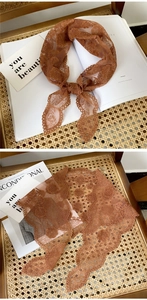 Detailed embroidery of vintage brown floral lace headscarf with hollowed mesh texture