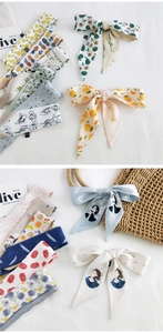 Selection of printed silk scarves featuring fruit, floral and retro art motifs for bag decor