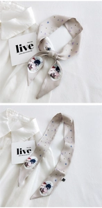 Detail of elegant slim silk scarf with butterfly print and vintage portrait illustration
