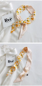 Detail of citrus print skinny scarf with Green Inspiration Ground text on 100% polyester