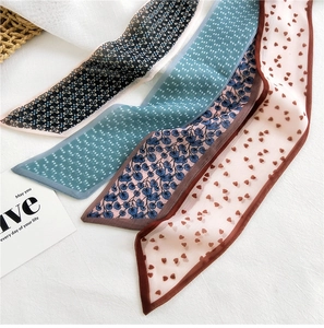 Detail of four floral skinny silk scarves with elegant prints for handbags and hair styling