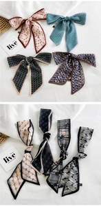 Detail of assorted printed floral and polka dot neck scarves in soft chiffon bows