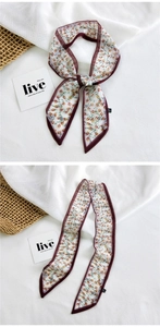 Close-up of lightweight floral narrow scarf with yellow prints and deep red borders