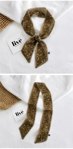 Detail of floral brown twilly scarf showing its tied knot and open 100% polyester fabric