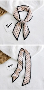 Detail of thin fashion scarf featuring dot-patterned lettering and black border trim
