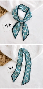 Detail of green floral checkerboard silk scarf tied as a bow on minimalist linen