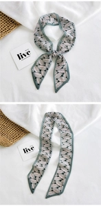Detail of floral skinny silk scarf with Morandi green leaf pattern and fine hemmed edges