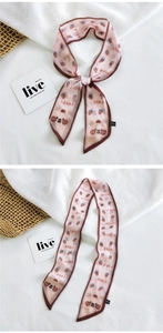 Detail of light pink bear and strawberry print silk scarf with brown edges
