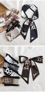 Detailed view of assorted silk-like twilly scarves with leopard and zebra prints