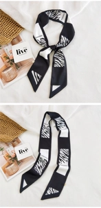 Detail of zebra pattern satin scarf tied on a basket with decorative magazine