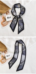 Detail of zebra pattern skinny silk scarf with Fashion lettering and grey contrast edge