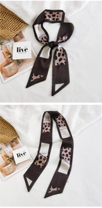 Close-up of slim leopard print silk scarf with brown color blocking and FASHION text
