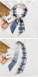 Detail of blue and white checkered narrow silk scarf with smooth satin finish texture