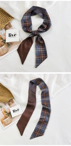Detailed view of a dark brown plaid twilly silk scarf tied on a handle and laid flat