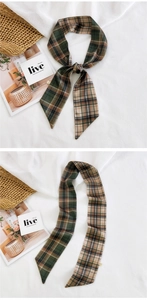 Macro detail of vintage green plaid silk scarf with pointed ends on white linen background