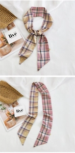 Detail of plaid silk scarf used as a stylish hair tie or neck accessory for women