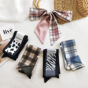 Assorted stylish silk hair scarves with leopard and check patterns on white fabric
