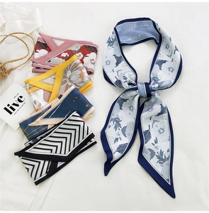 Detailed view of floral and geometric long silk twilly scarves for hair and bags