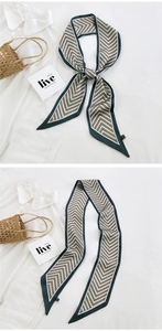 Detail of silk narrow scarf with herringbone print tied on a bag handle and shirt