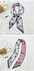 Detail of pink floral twilly silk scarf tied on a bag handle and spread out flat