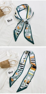 Close-up of zebra pattern silk twilly scarf tied on handle with equestrian elements