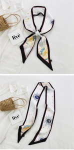 Detail of narrow silk scarf with celestial prints and contrasting borders for styling