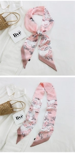 Detailed close-up of pink silk-feel twilly scarf with horse and floral prints on a shirt