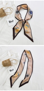 Detail of elegant champagne long silk scarf featuring vintage astrology and star patterns