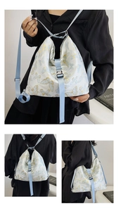 Detailed view of white floral backpack with blue straps and stylish butterfly print pattern