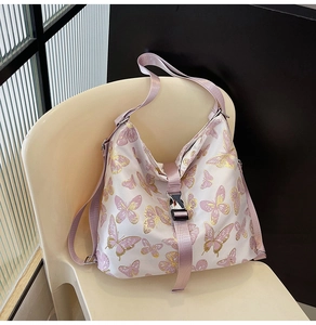 Detail of pink butterfly print tote bag with snap closure and durable textile strap