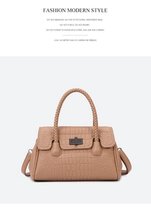 Close-up of camel crocodile pattern handbag with woven handle and gold metal lock