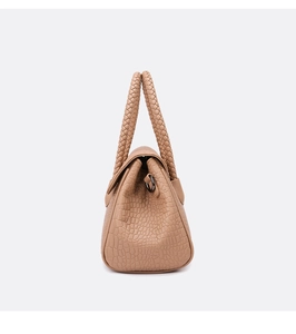 Detail view of brown crocodile embossed handbag with unique braided rope handle design