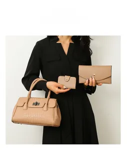 Three-piece beige handbag set featuring embossed crocodile texture and braided handles