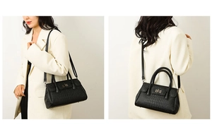 Close-up of black crocodile embossed handbag featuring woven handles and metal turn-lock