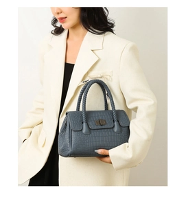 Blue crocodile embossed handbag with woven handles and vintage bronze clasp closure