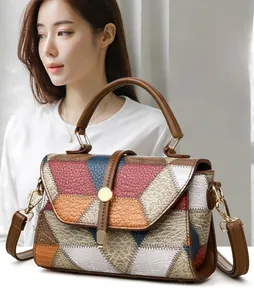 Detail showing the patchwork animal texture leather on a stylish handbag with a brown handle