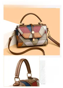 Detail view of contrast color handbag with lychee texture leather and metal buckle
