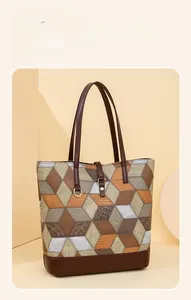 Detail of color-block tote bag featuring 3D geometric patterns and textured PU leather