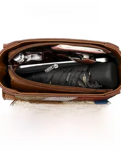 Detail view of multi-compartment interior storage in a color-block crossbody handbag