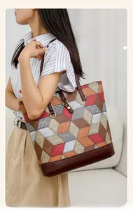 Detailed close-up of geometric color-block tote bag with 3D diamond pattern leather