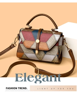 Macro detail of geometric color-block leather texture and golden metal buckle on handbag