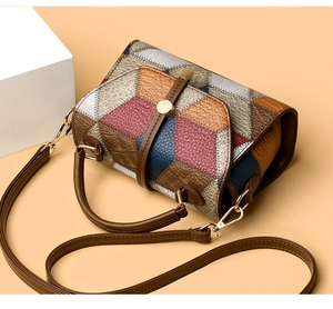 Detail of geometric color-block patchwork and lychee texture on this chic small crossbody bag