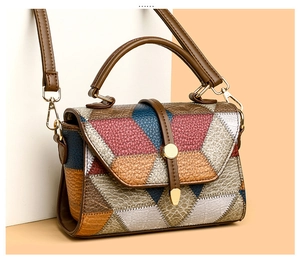 Detailed view of color-block patchwork leather handbag with lychee texture and gold lock