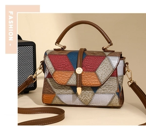 Macro view of geometric color-block handbag with textured leather and gold clasp