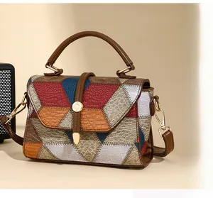 Detail of vintage patchwork handbag with various embossed leather textures and gold hardware