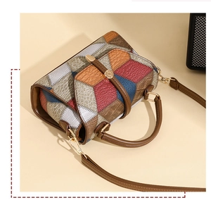 Macro detail of multi-color patchwork leather textures and gold metallic hardware of the bag