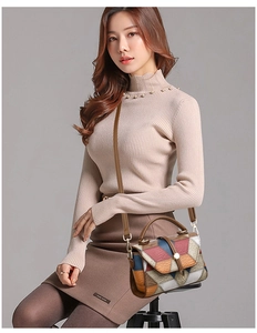 Detail of color-block crossbody bag with lychee texture and metallic twist lock closure