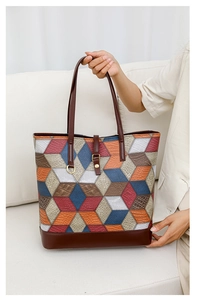 Close-up of geometric puzzle patchwork tote with embossed crocodile and lychee textures