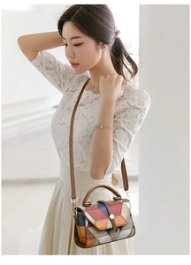 Detail of color-block geometric pattern crossbody bag with pebbled leather texture