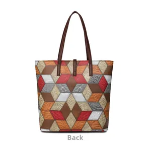 Detailed back view of a color-block tote bag showing geometric faux leather textures